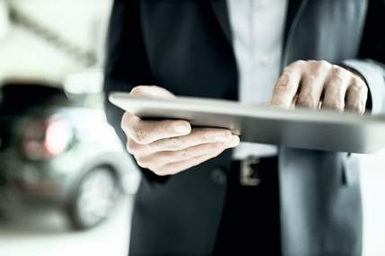 Derivate: Erklärung von Termingeschäften Person, die an einem Tablet Derivate erklärt